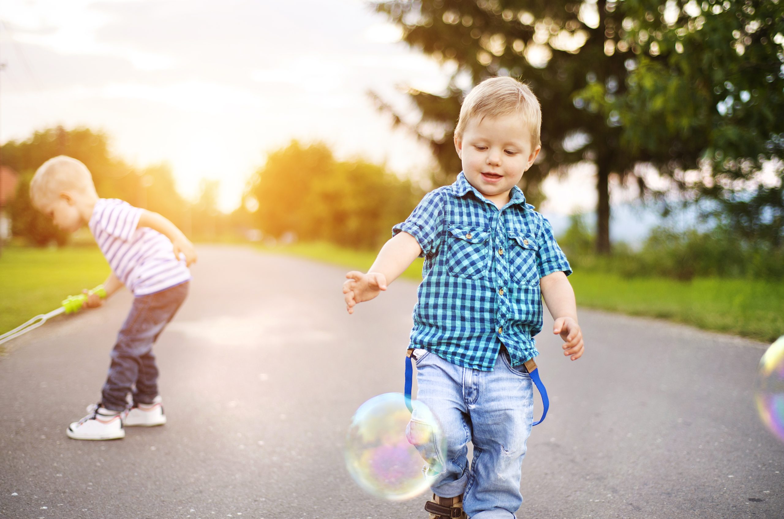 Little boys playing outside the house